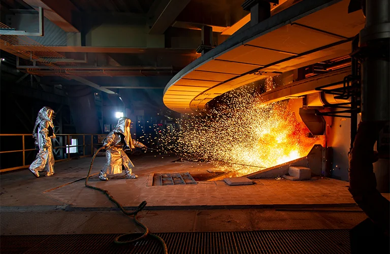 Paper mill with yellow overhead crane and large paper rolls